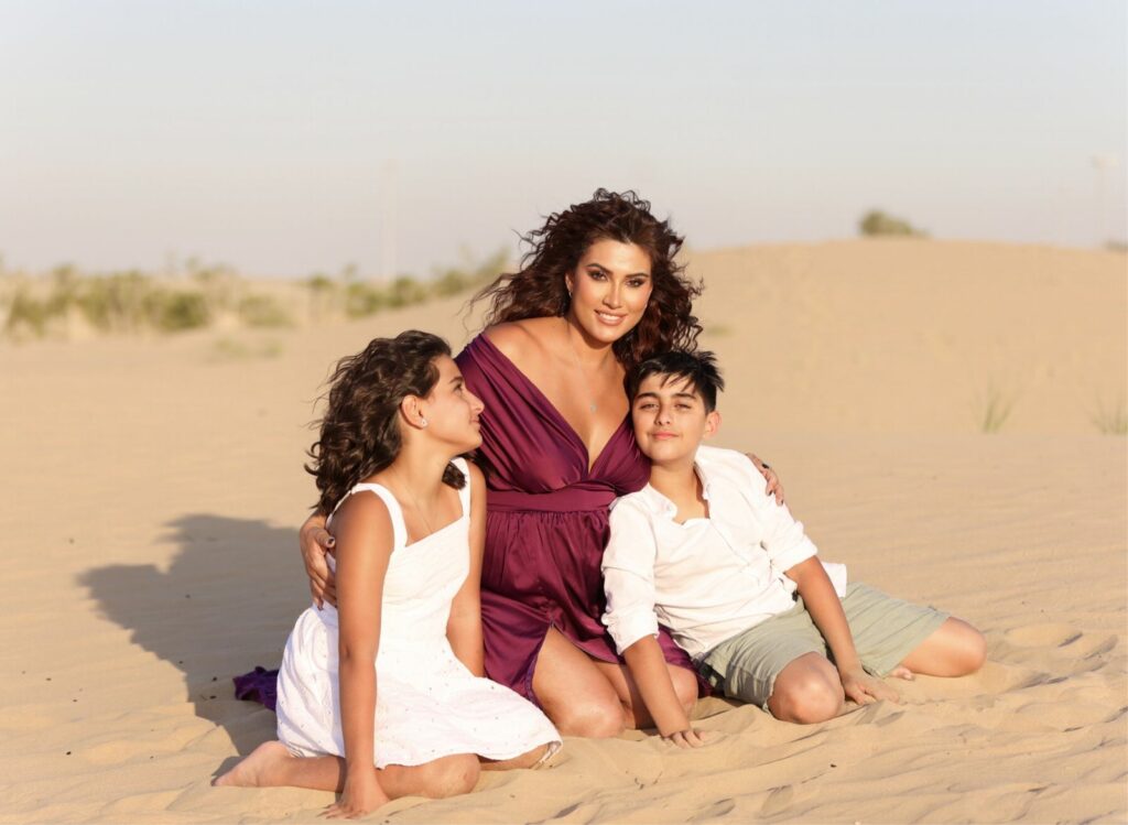 Dr. Rafif Tayara, pediatric dentist in Dubai, with her twins in the Dubai desert