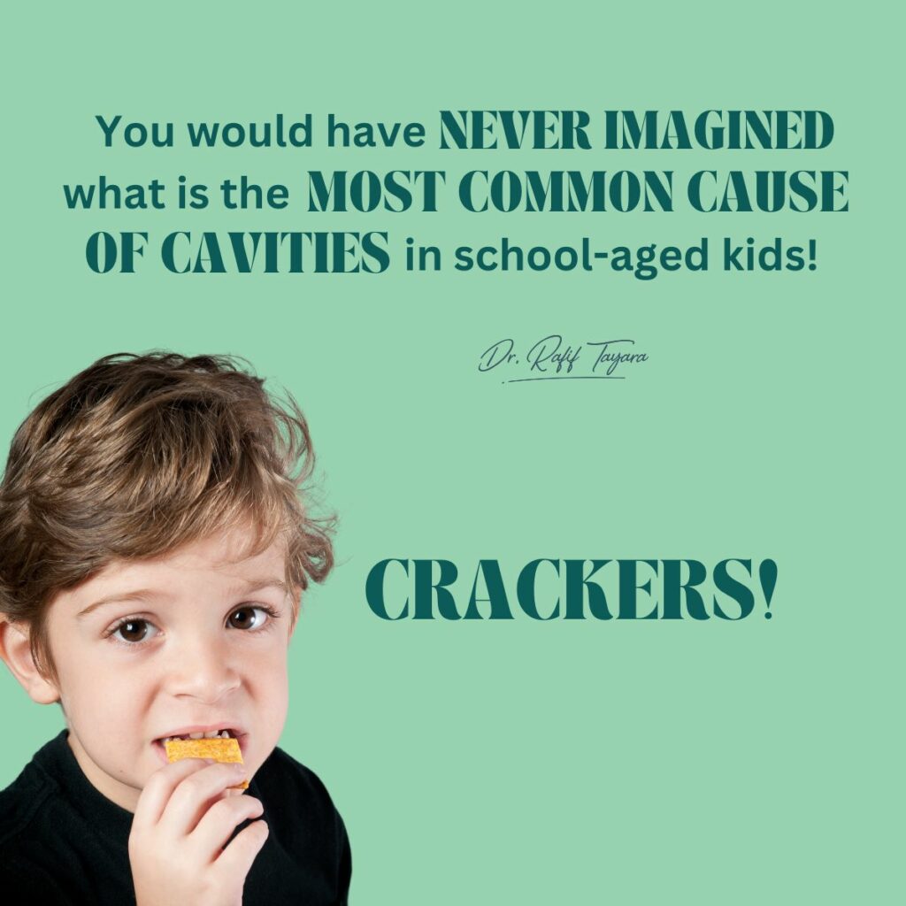 A young boy eating a cracker, illustrating the most common cause of cavities in school-aged children