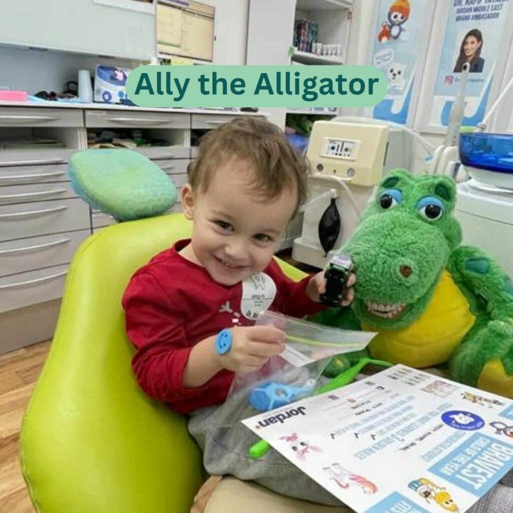 Child brushing Ally the Alligator’s teeth in the dental chair at a kids dentist in Dubai